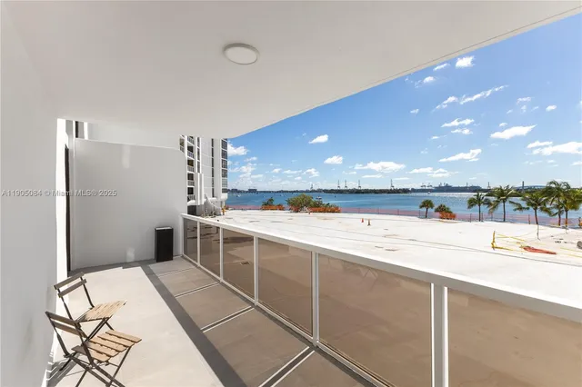 a view of a kitchen with a sink and refrigerator