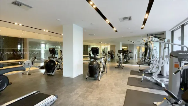a gym room with lots of gym equipment
