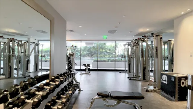 a room with lots of wooden furniture and a large window