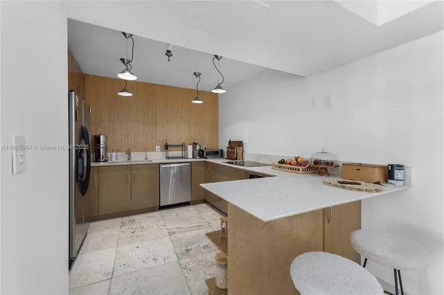 a kitchen with a sink a counter top space and appliances