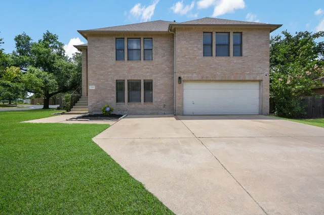 a front view of a house with a yard and garage