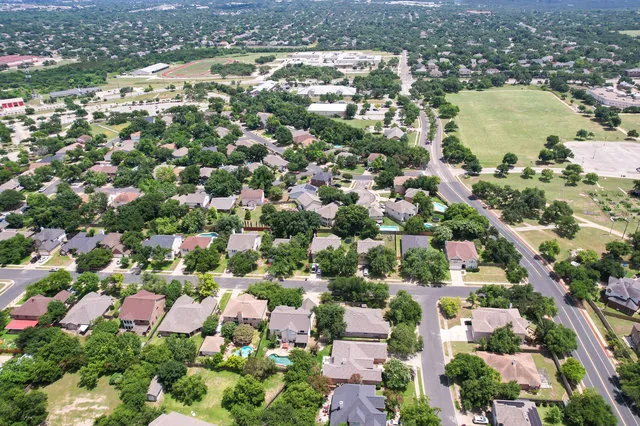 an aerial view of residential houses with outdoor space
