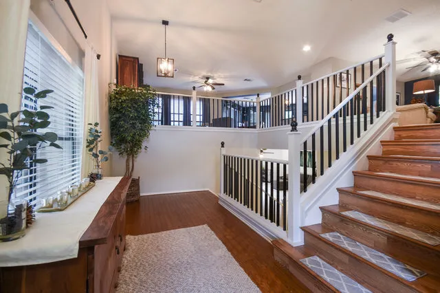 a view of entryway and hall with wooden floor
