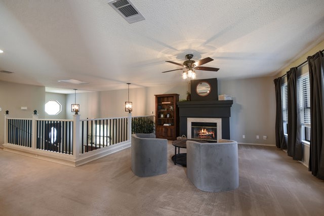 1750 Star Light Circle Cedar Park, TX 78613 - Photo 6 of 40 a living room with furniture a fireplace and a ceiling fan