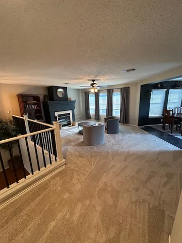 a view of a livingroom with furniture and staircase