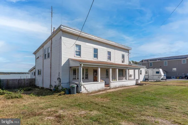 a backyard of a house with yard and outdoor seating