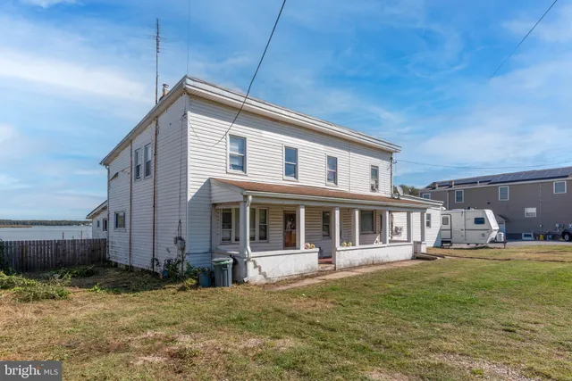 a backyard of a house with yard and outdoor seating