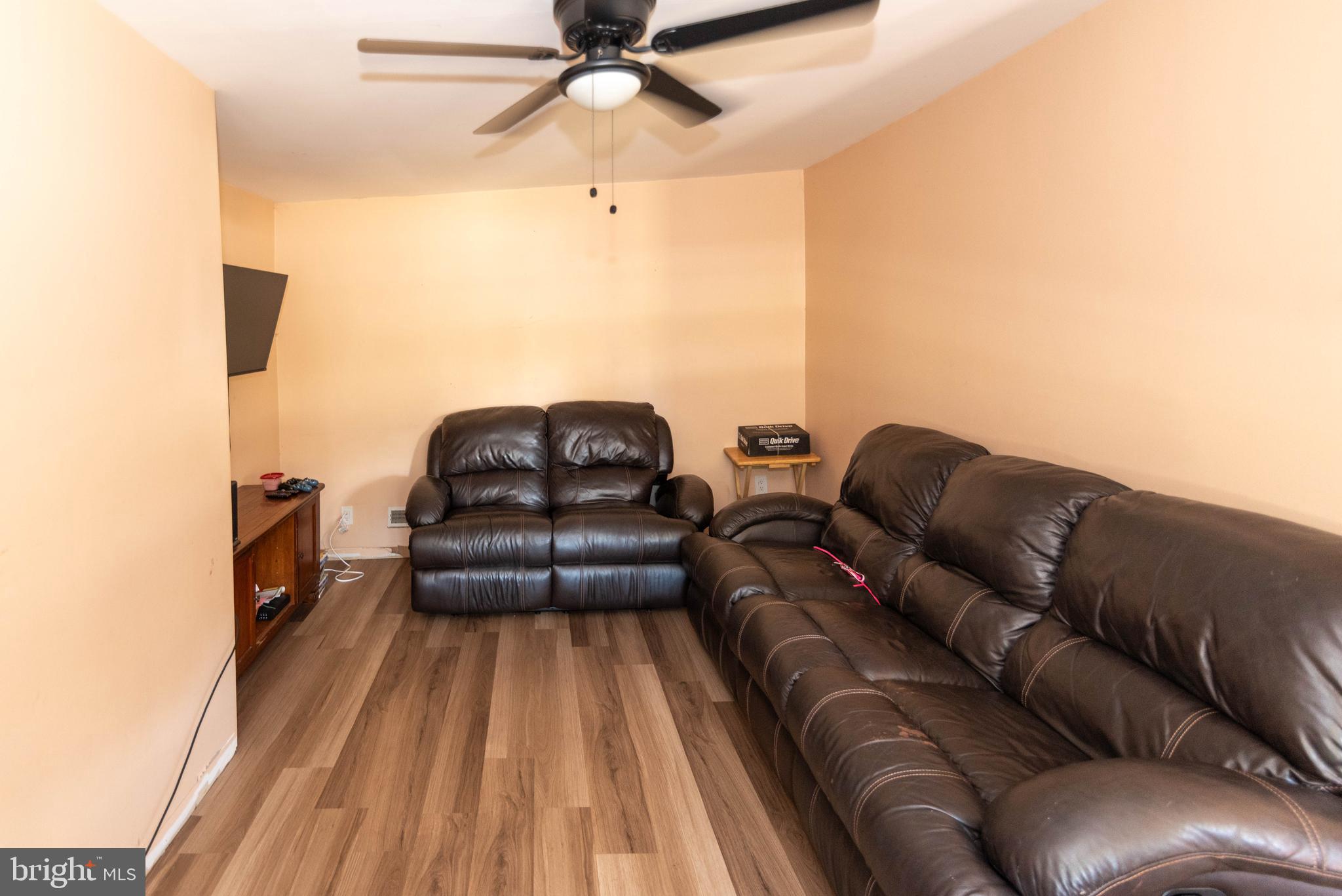 6510 North Point Road Edgemere, MD 21219 - Photo 13 of 56 a living room with a couch and a wooden floor