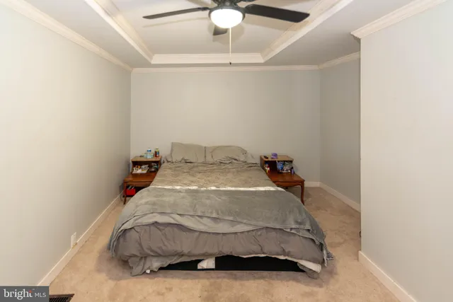 a bedroom with a bed and a ceiling fan