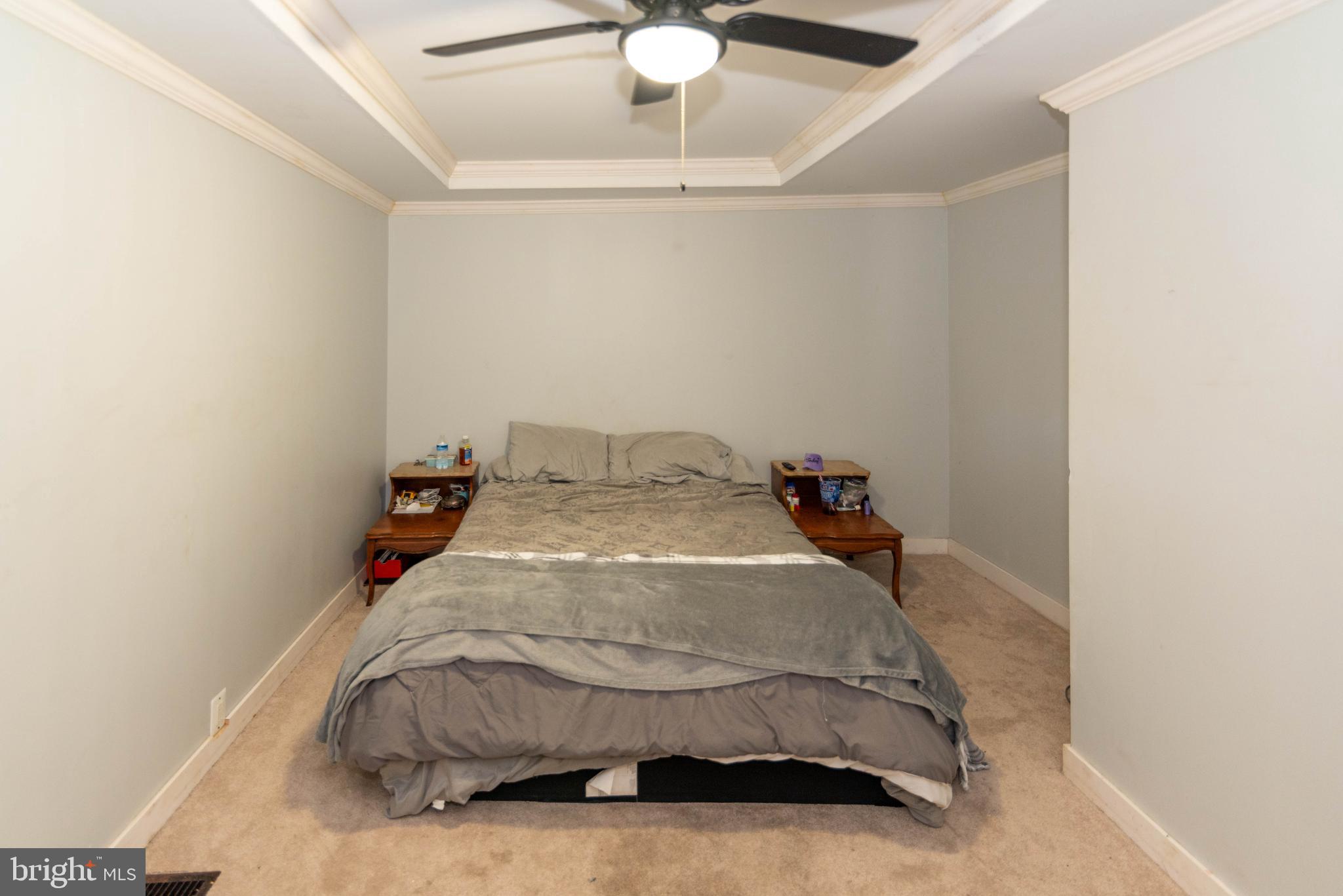6510 North Point Road Edgemere, MD 21219 - Photo 15 of 56 a bedroom with a bed and a ceiling fan