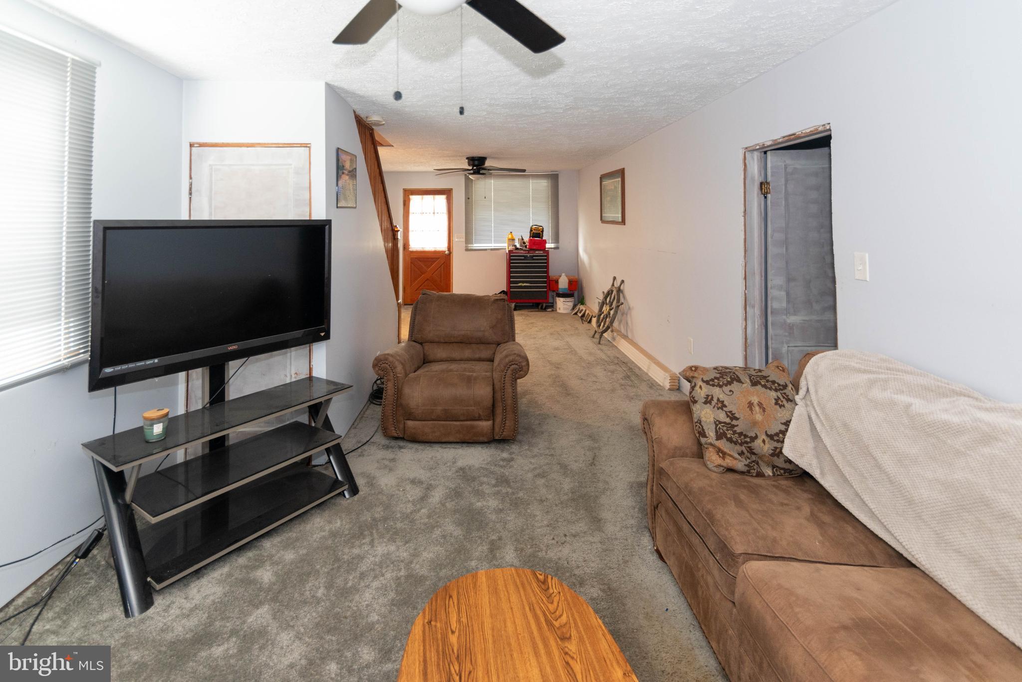 6510 North Point Road Edgemere, MD 21219 - Photo 28 of 56 a living room with furniture and a flat screen tv