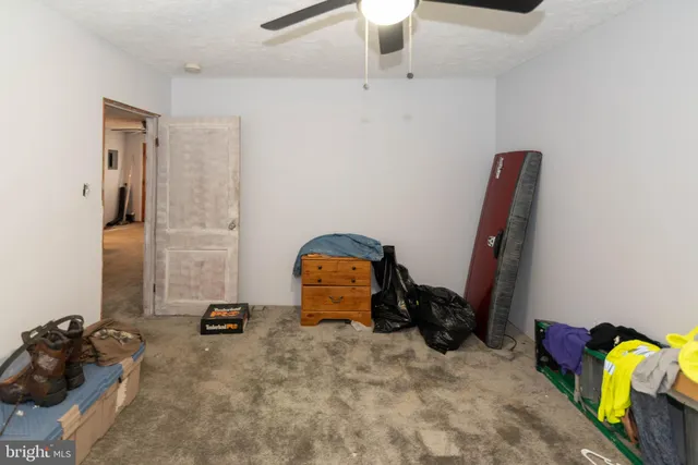 a kitchen with a table chairs refrigerator and microwave