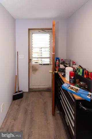 a kitchen with stainless steel appliances granite countertop a stove a refrigerator a sink a dining table and chairs