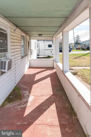 a view of a large room with wooden floor and windows