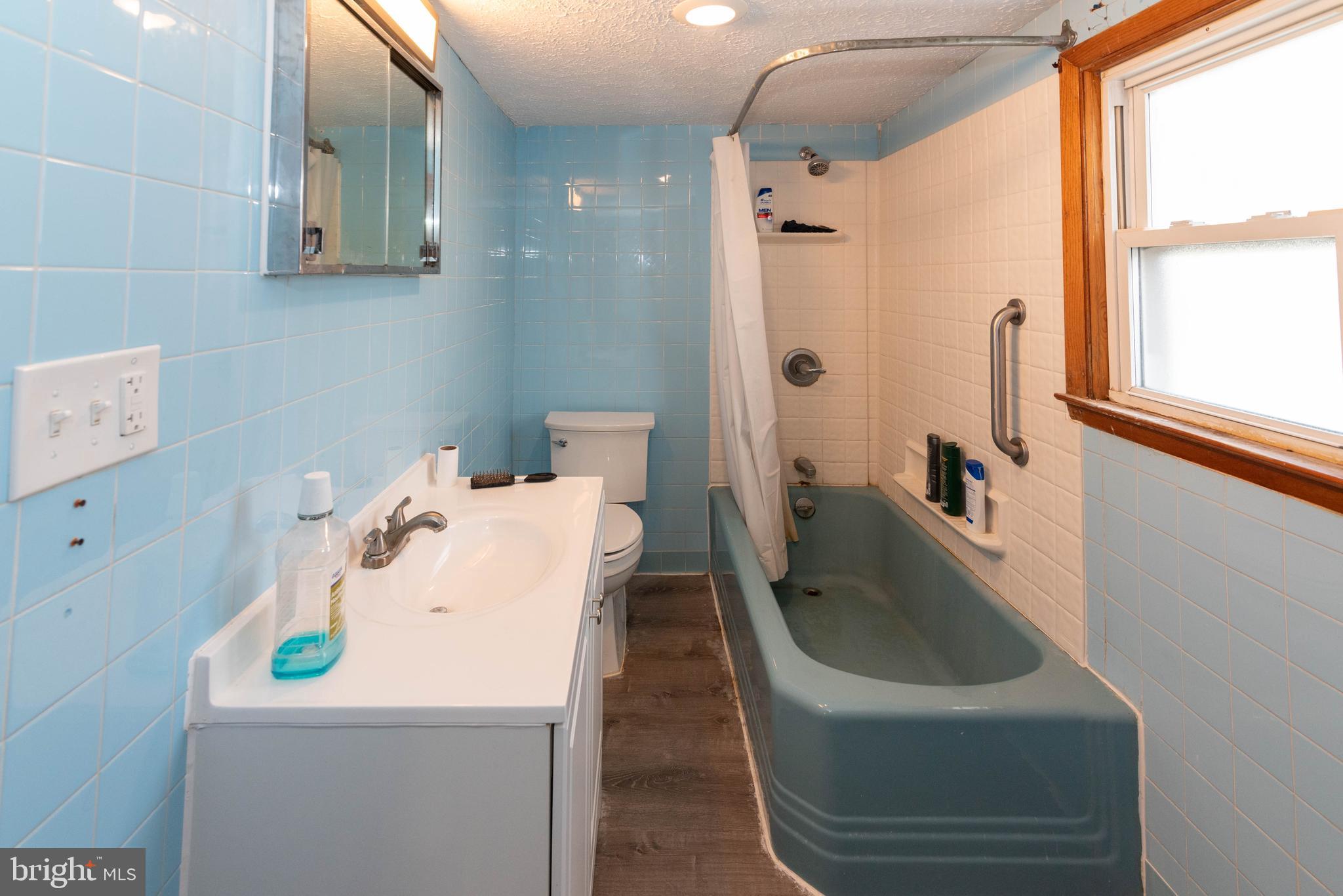 6510 North Point Road Edgemere, MD 21219 - Photo 45 of 56 a bathroom with a sink and mirror with bathtub