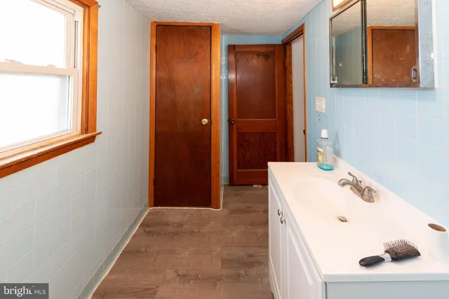 a room with water heater and wooden racks