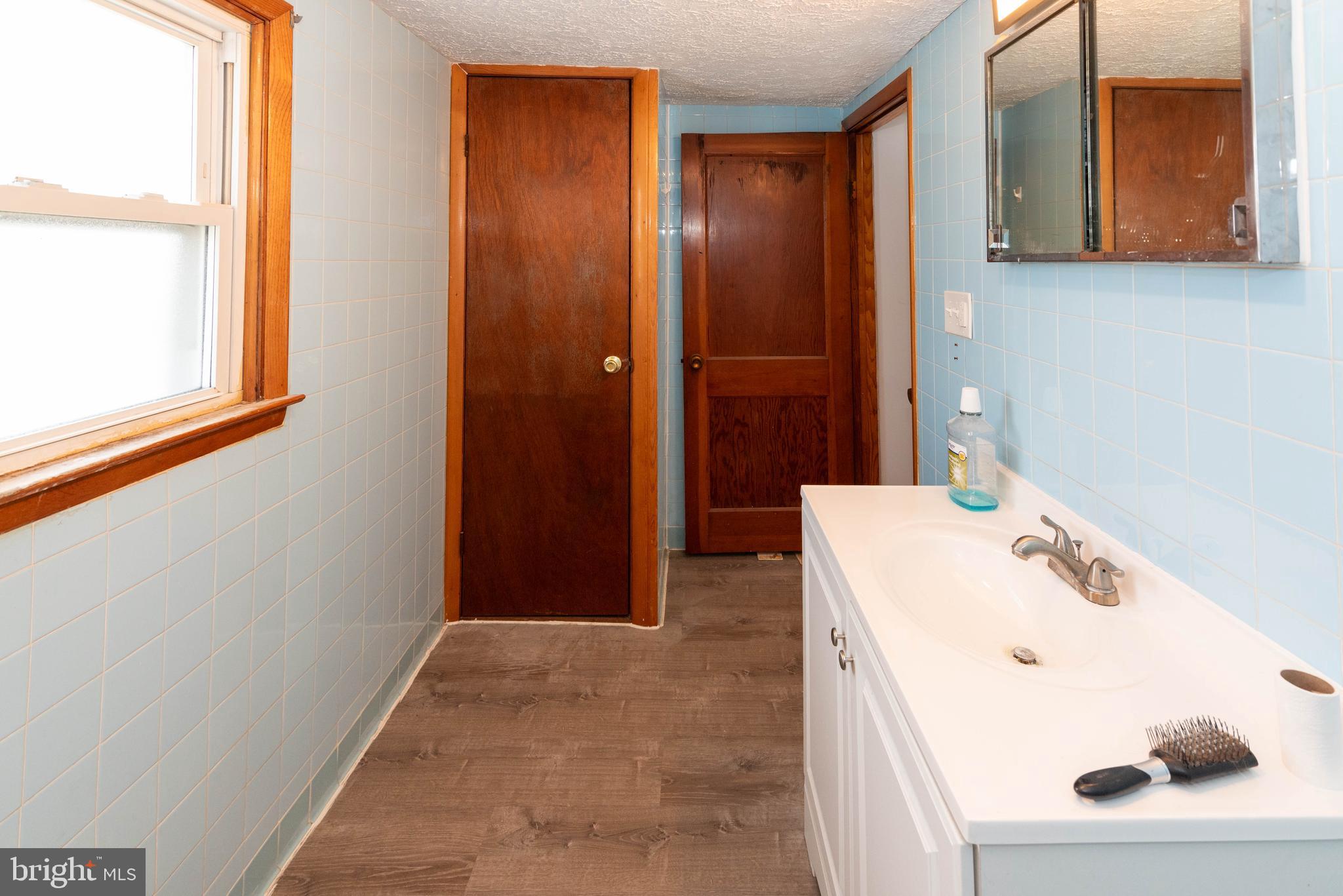6510 North Point Road Edgemere, MD 21219 - Photo 46 of 56 a bathroom with a sink and a mirror