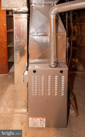 a room with water heater and a wooden floor