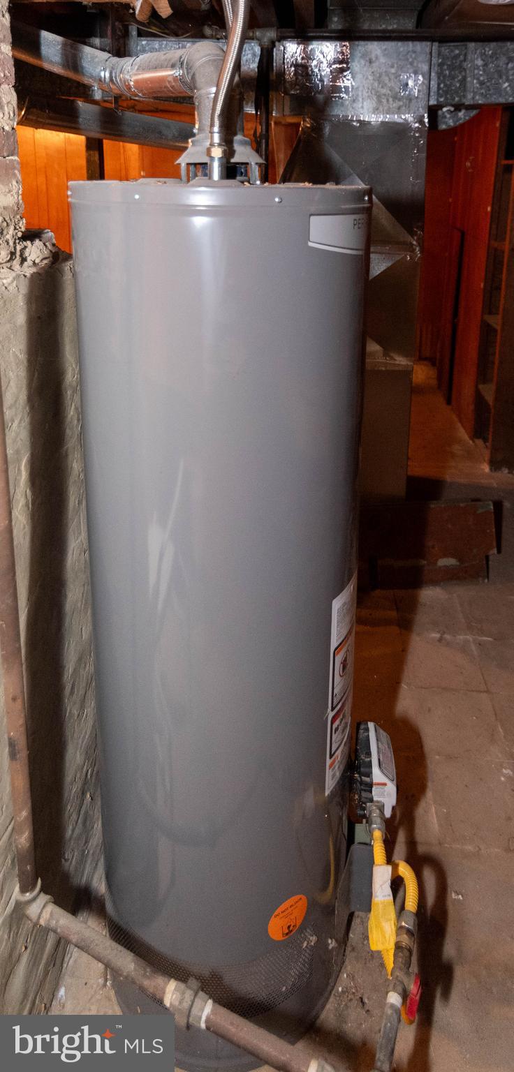 6510 North Point Road Edgemere, MD 21219 - Photo 51 of 56 a room with water heater and wooden racks