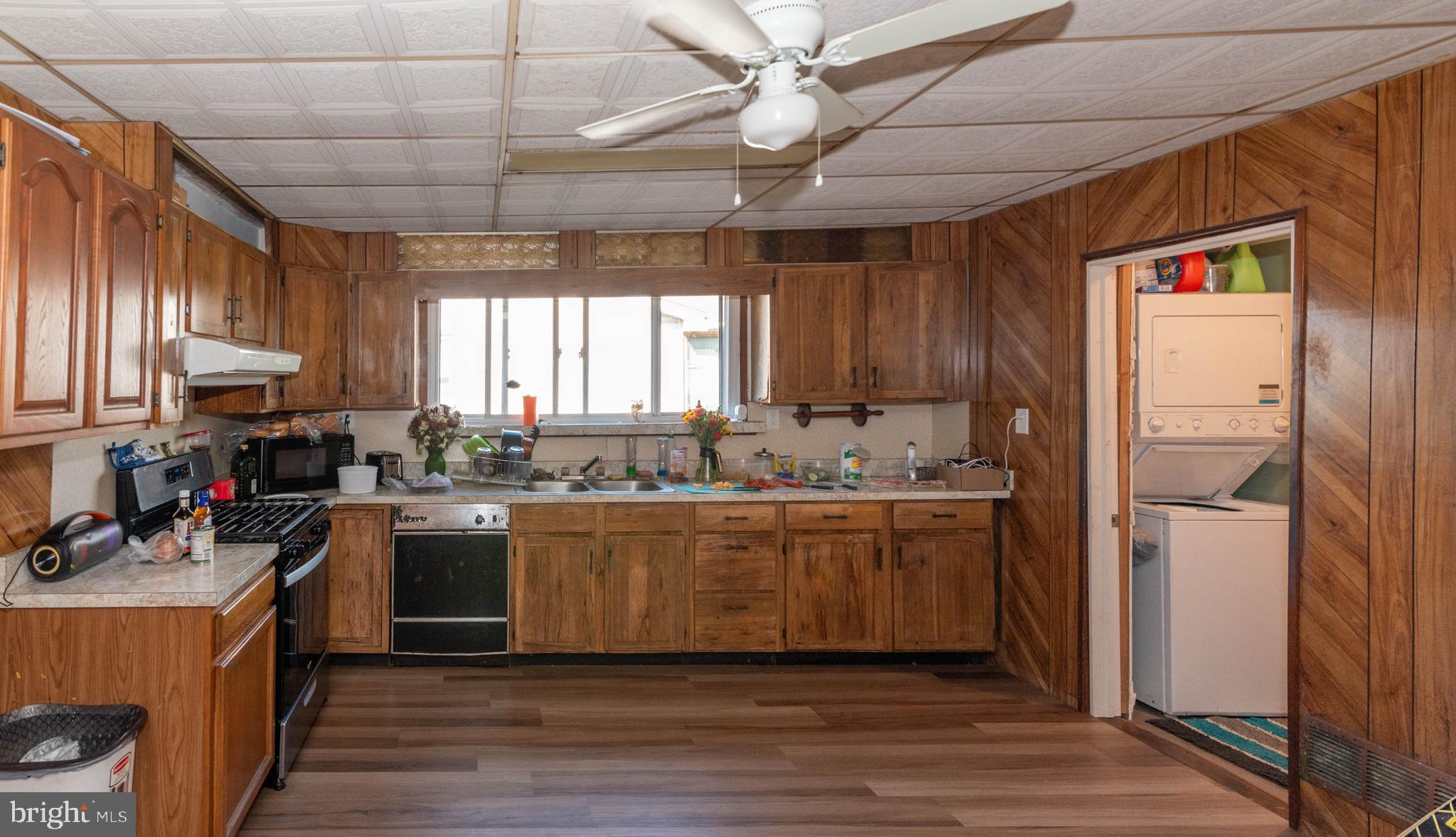 6510 North Point Road Edgemere, MD 21219 - Photo 6 of 56 a kitchen with kitchen island granite countertop a sink cabinets and stainless steel appliances