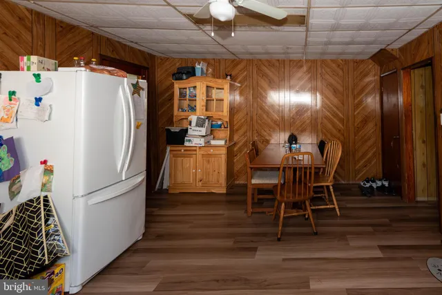 a kitchen with granite countertop a refrigerator and a chair