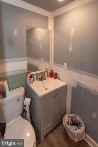 a bathroom with a sink mirror vanity and toilet