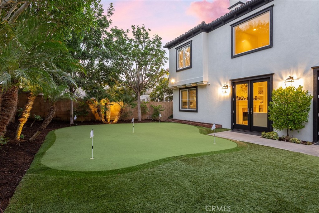 8 Madison Newport Beach, CA 92660 - Photo 16 of 34 a view of a house with a backyard and a tree