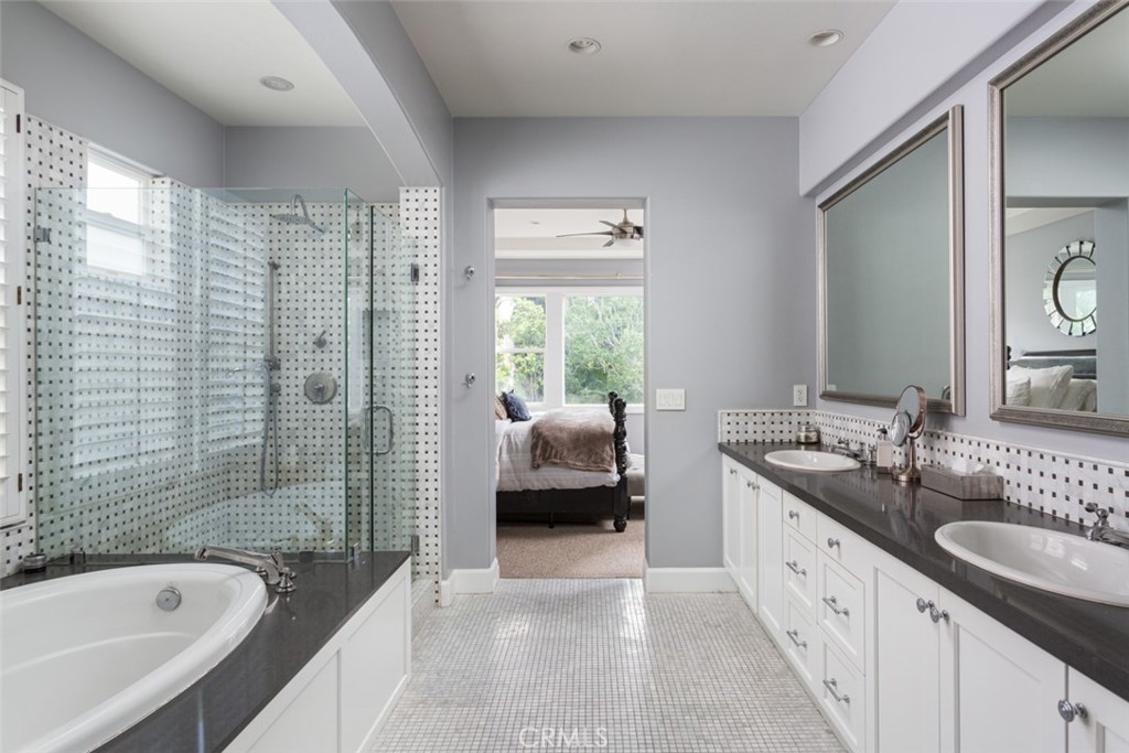 8 Madison Newport Beach, CA 92660 - Photo 18 of 34 a en suite bathroom with a granite countertop tub sink and mirror