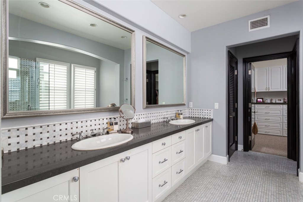 8 Madison Newport Beach, CA 92660 - Photo 19 of 34 a bathroom with double sink and a mirror