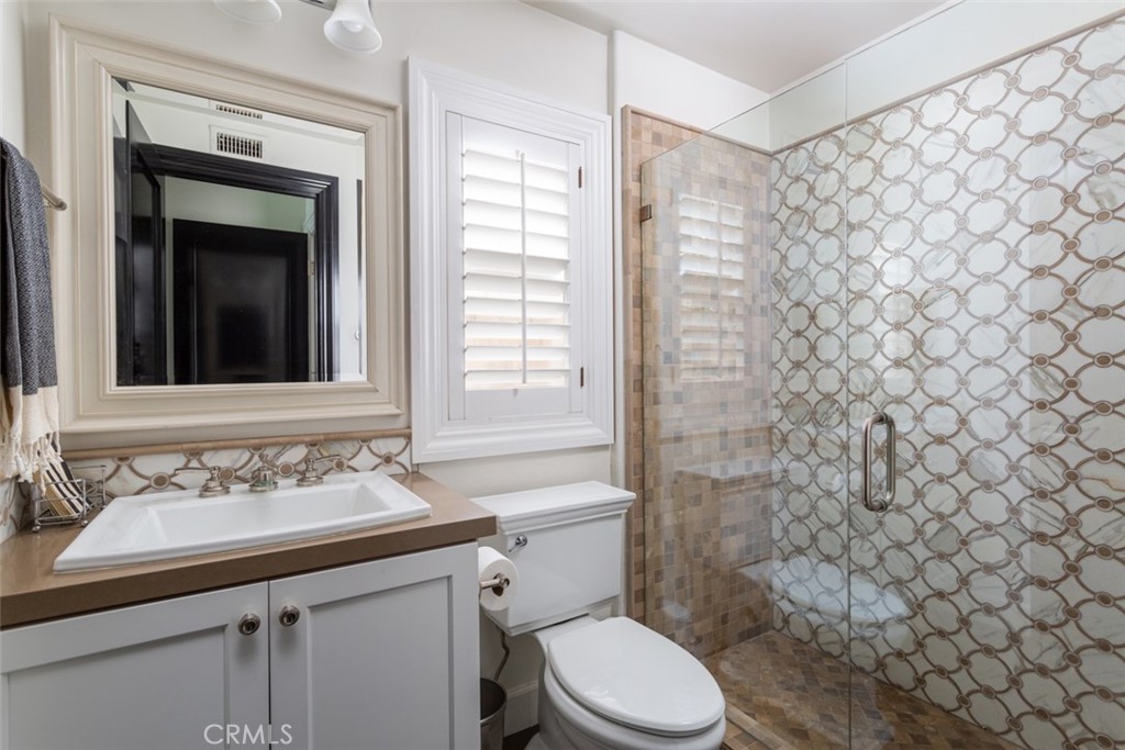 8 Madison Newport Beach, CA 92660 - Photo 24 of 34 a bathroom with a sink a toilet and shower