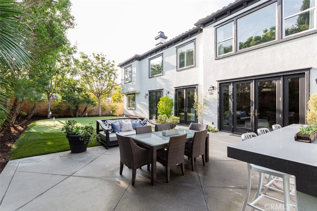8 Madison Newport Beach, CA 92660 - Photo 31 of 34 a view of a patio with dining table and chairs