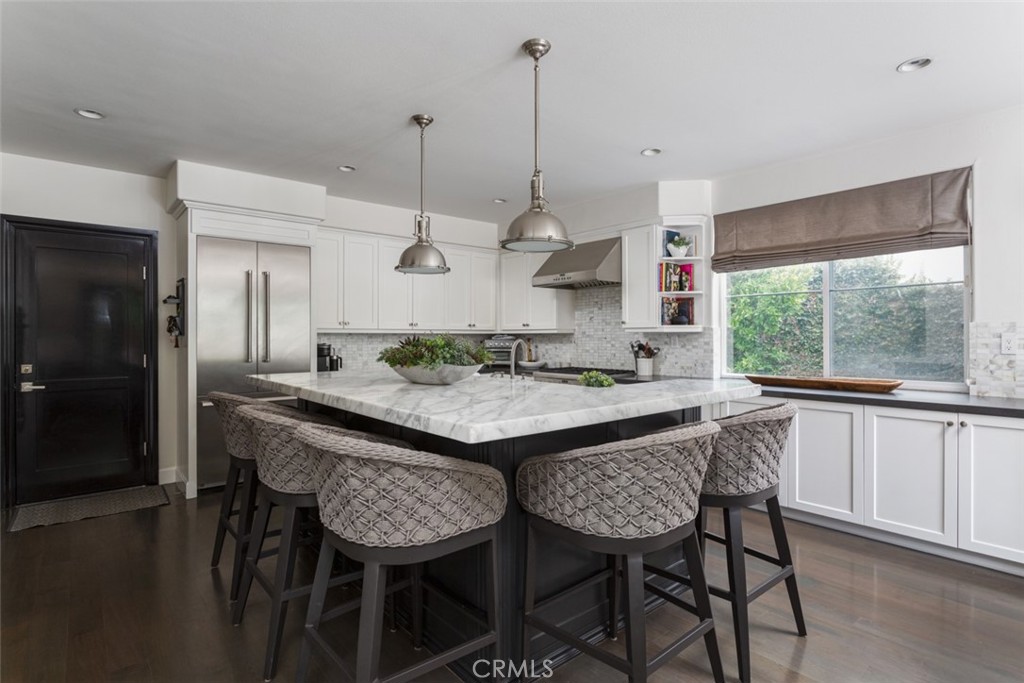 8 Madison Newport Beach, CA 92660 - Photo 8 of 34 a large kitchen with a table and chairs