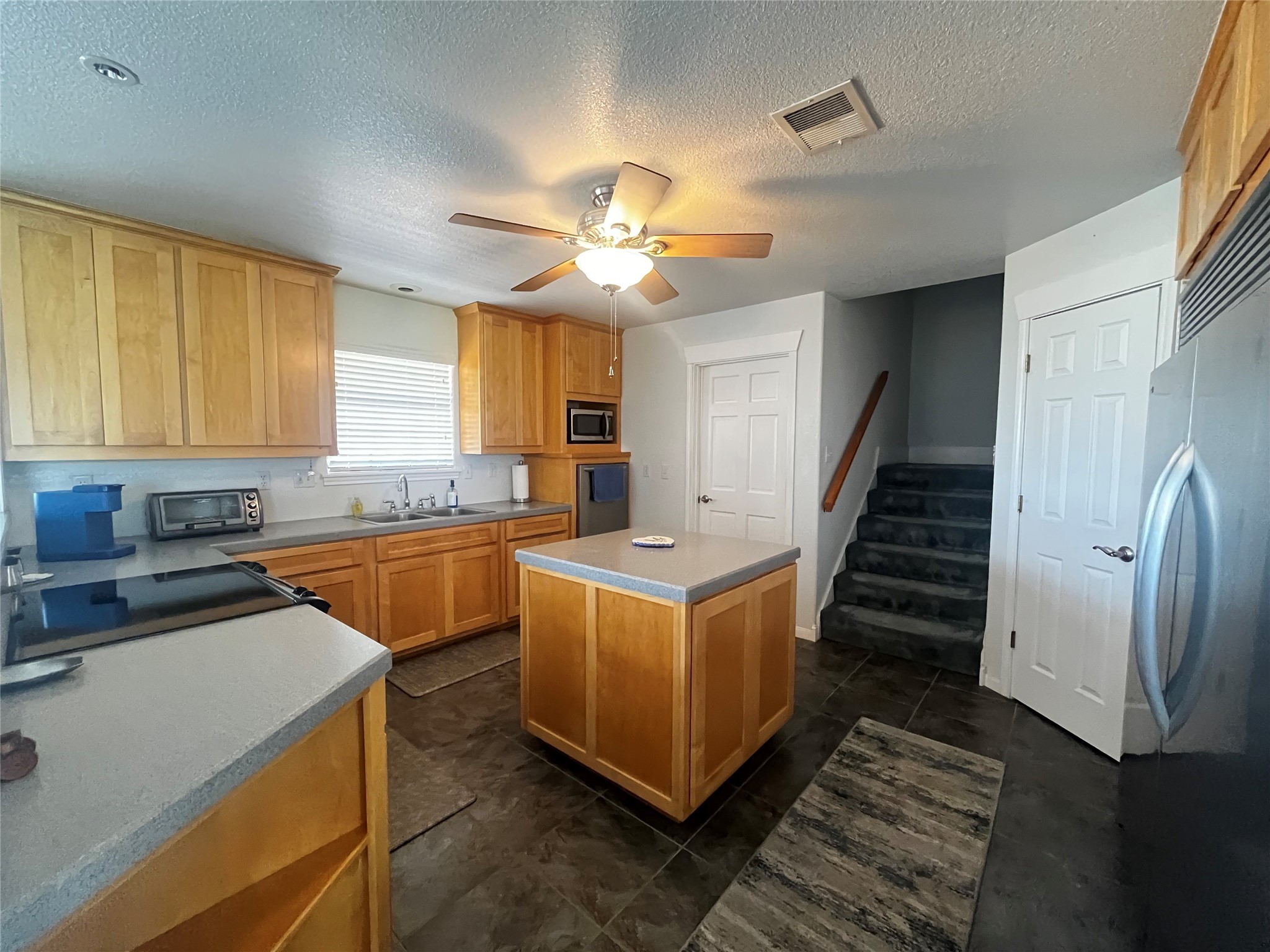 1100 Swiss Alp Hills Loop Schulenburg, TX 78956 - Photo 15 of 46 a kitchen with sink a stove and cabinets