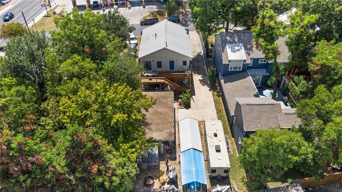 an aerial view of a house with yard and parking spaces