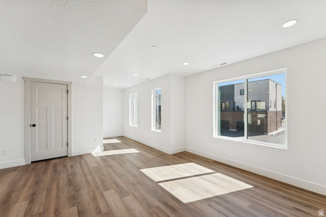 252 North Main Street Bountiful, UT 84010 - Photo 13 of 34 Empty room with light wood-type flooring, healthy amount of natural light, and recessed lighting