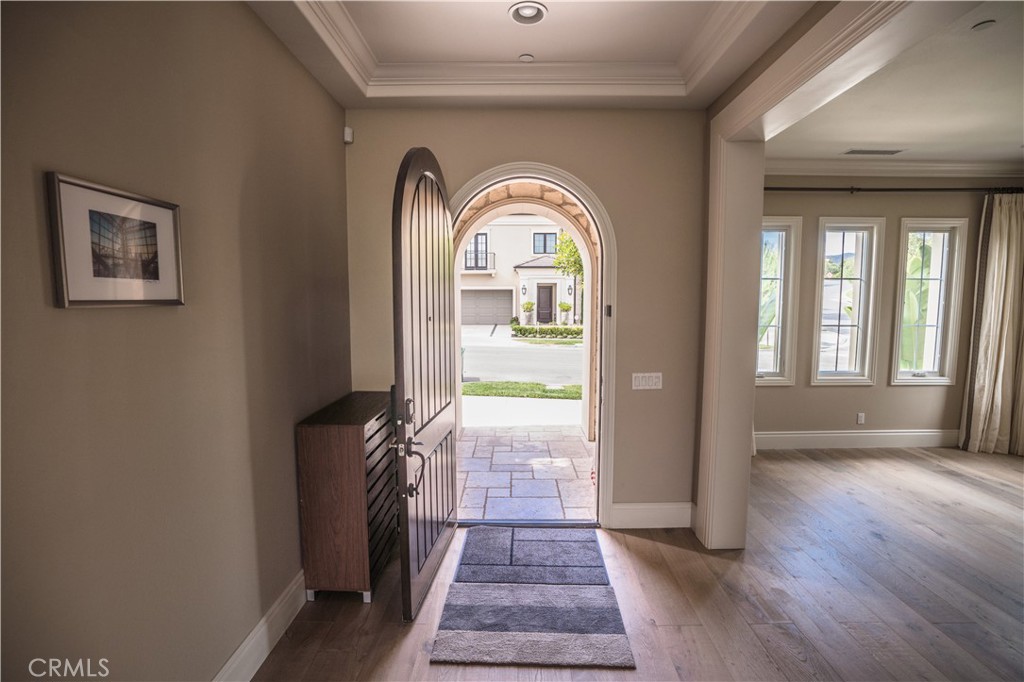 a view of a hallway with wooden floor and a fireplace