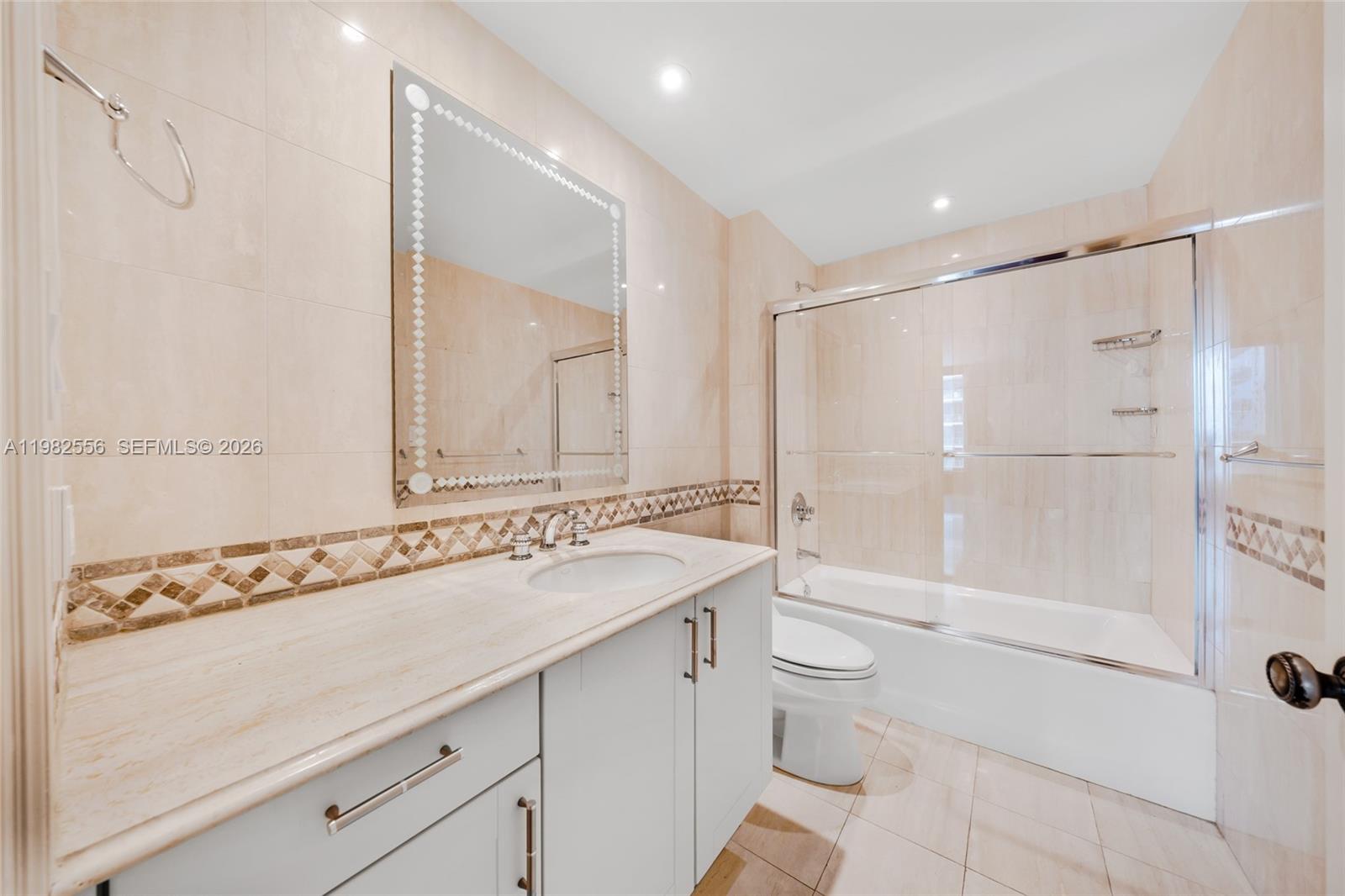 430 Grand Bay Drive, Unit 902 Key Biscayne, FL 33149 - Photo 31 of 87 a bathroom with a granite countertop sink a toilet and shower