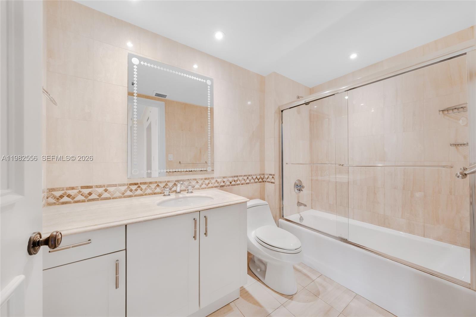 430 Grand Bay Drive, Unit 902 Key Biscayne, FL 33149 - Photo 37 of 87 a bathroom with a sink a toilet and shower