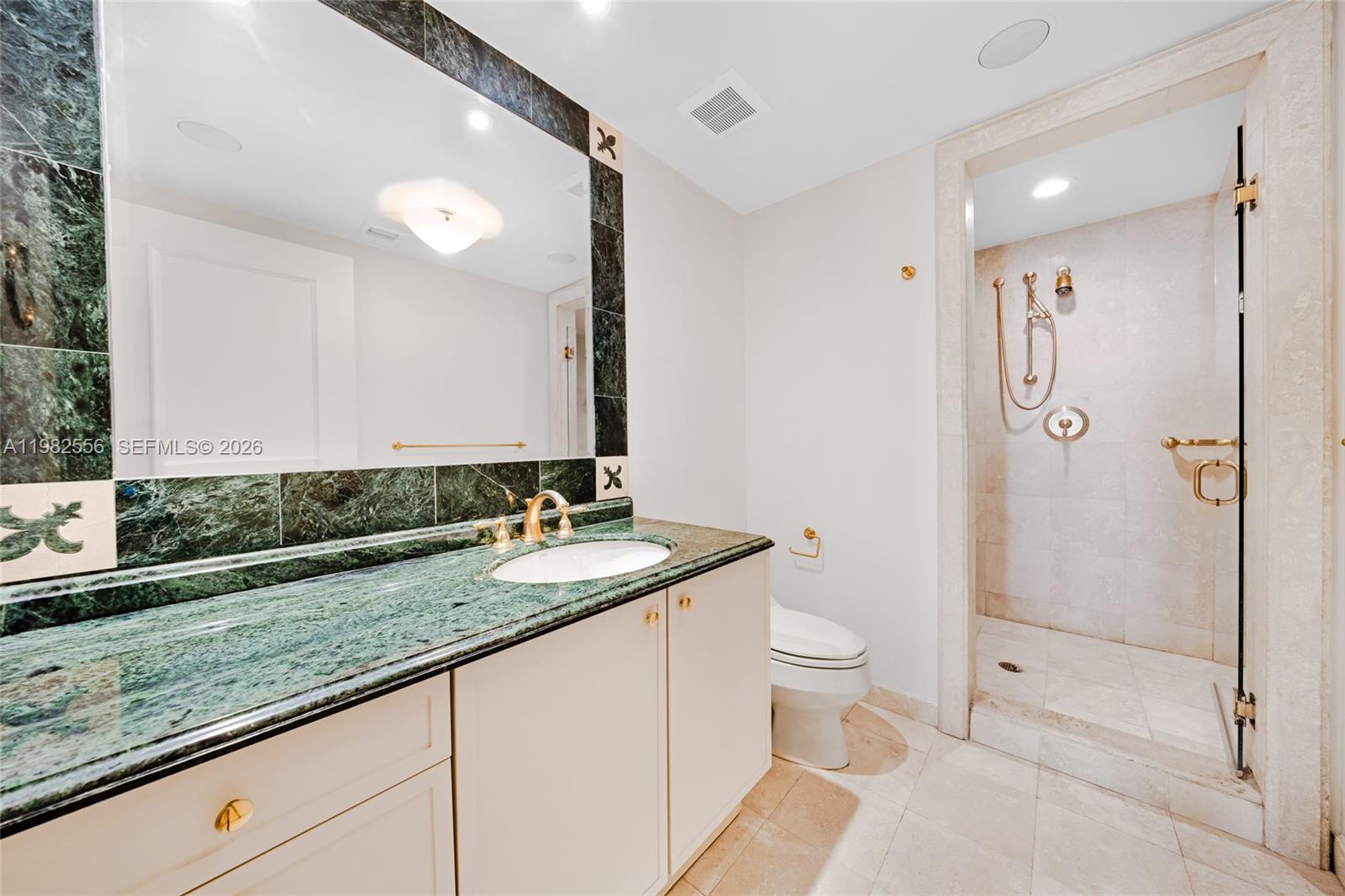 430 Grand Bay Drive, Unit 902 Key Biscayne, FL 33149 - Photo 50 of 87 a bathroom with a granite countertop sink a toilet a mirror and shower