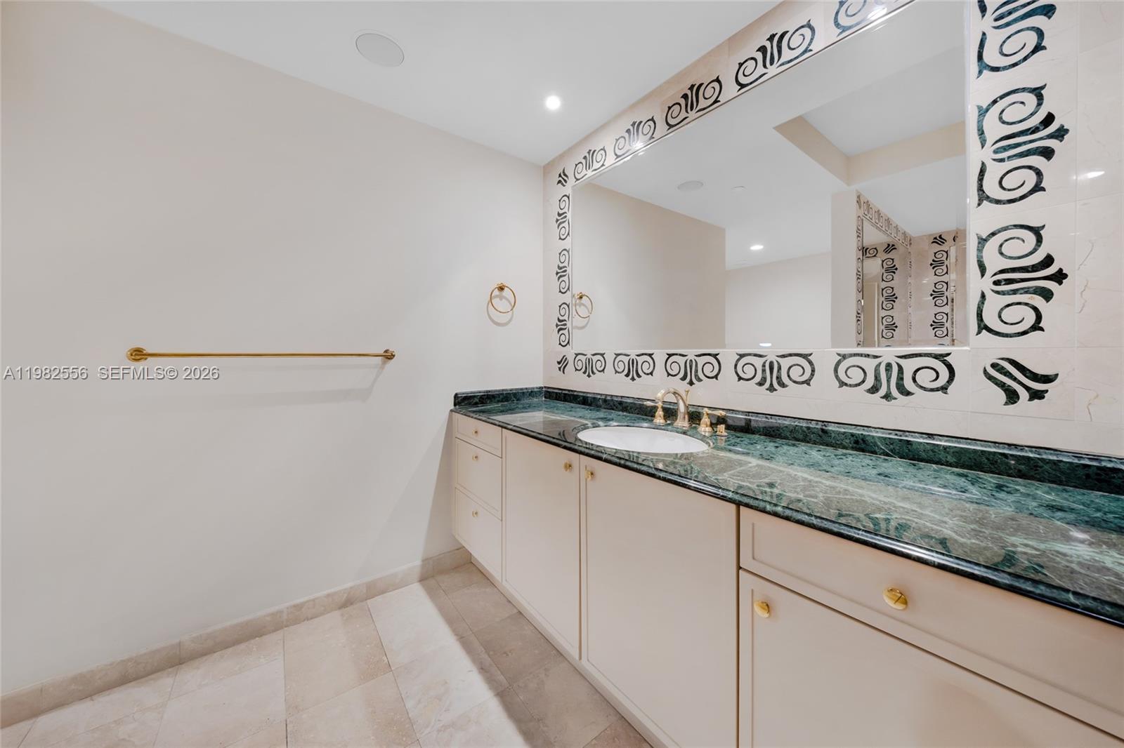 430 Grand Bay Drive, Unit 902 Key Biscayne, FL 33149 - Photo 52 of 87 a kitchen with granite countertop a sink and a white cabinets
