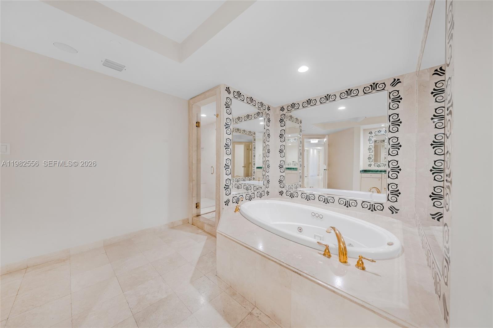 430 Grand Bay Drive, Unit 902 Key Biscayne, FL 33149 - Photo 54 of 87 a spacious bathroom with a tub sink and mirror