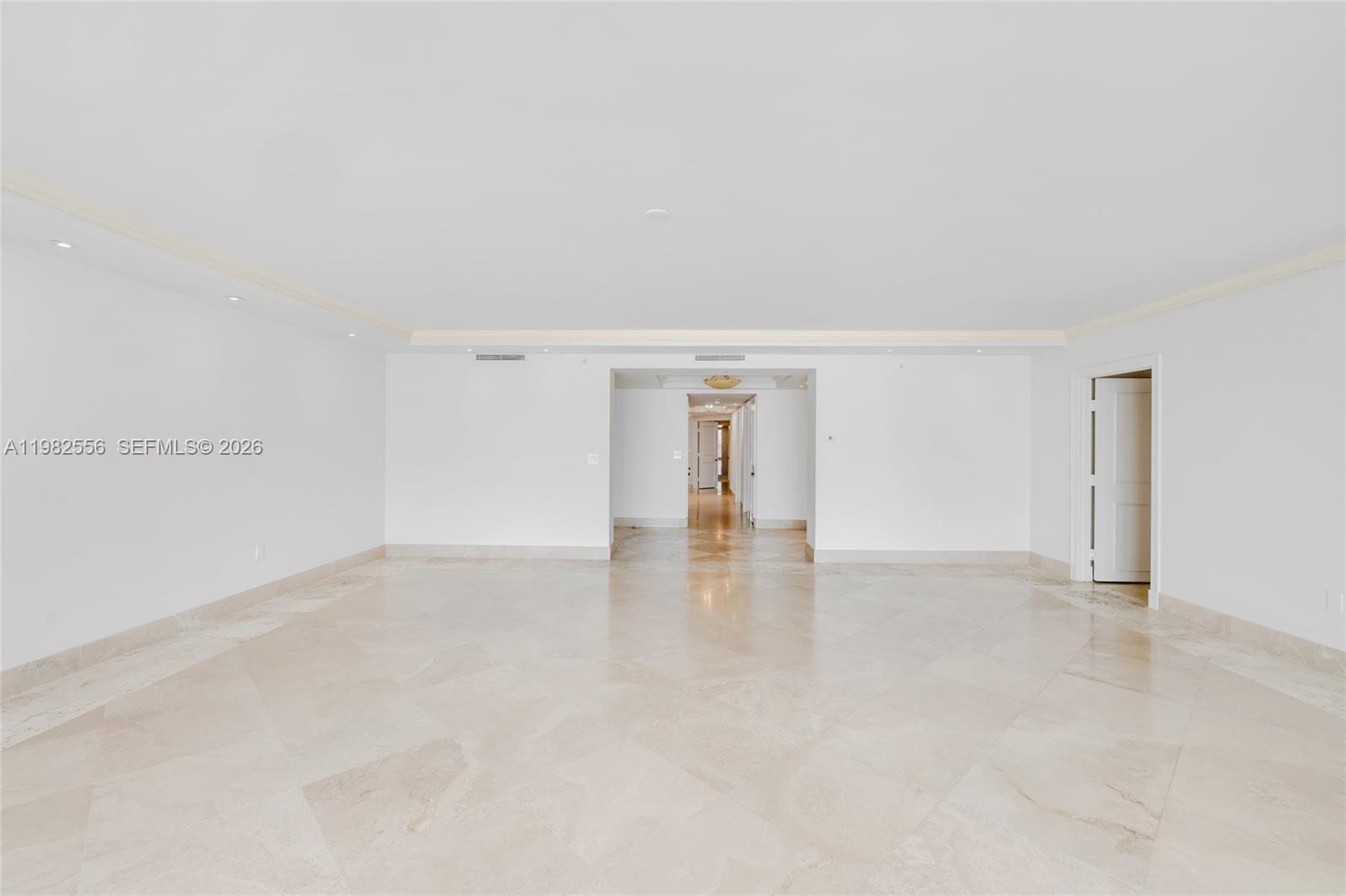 430 Grand Bay Drive, Unit 902 Key Biscayne, FL 33149 - Photo 6 of 87 a view of an empty room with wooden floor and a window