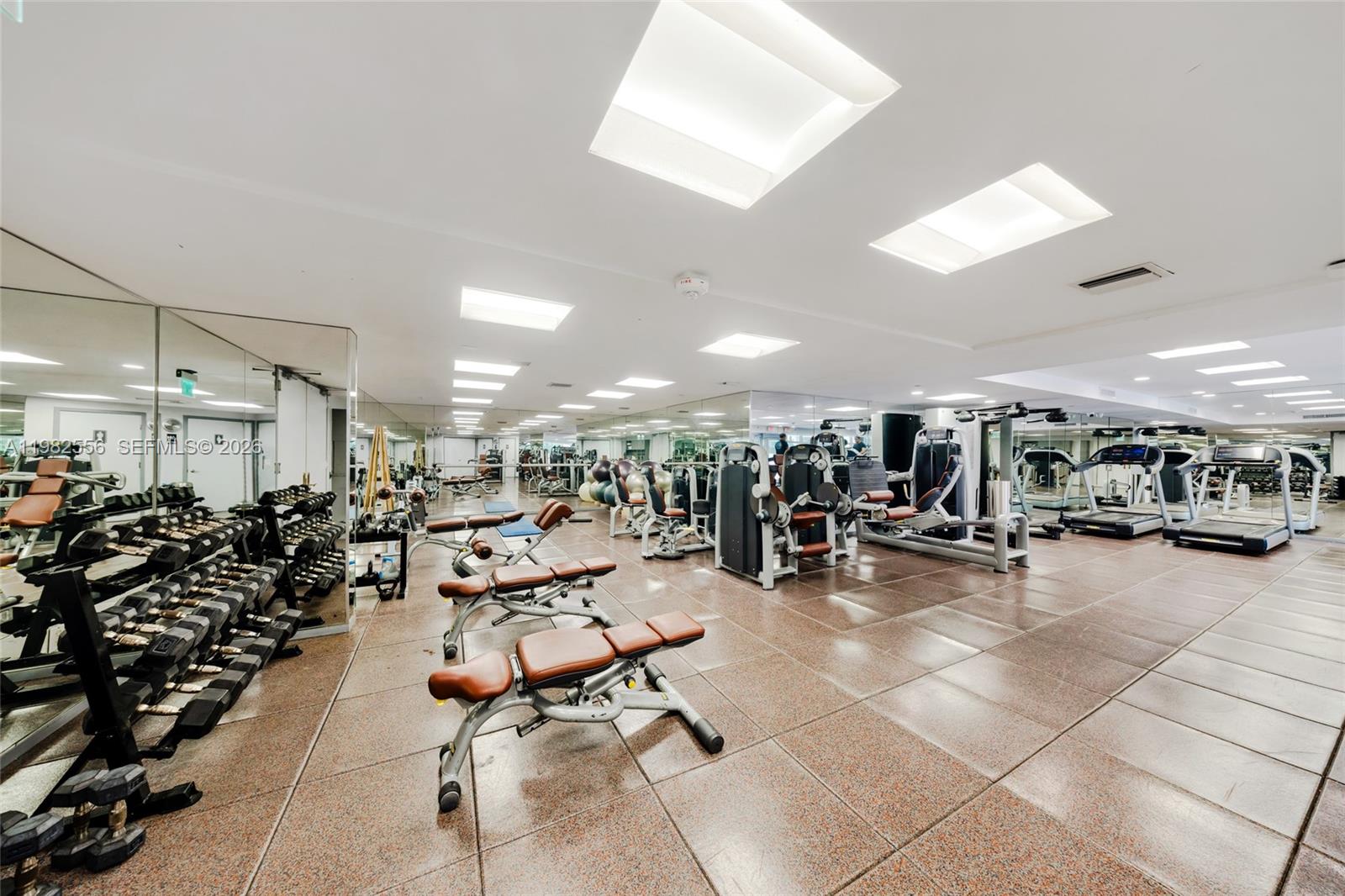 430 Grand Bay Drive, Unit 902 Key Biscayne, FL 33149 - Photo 77 of 87 a view of a room with gym equipment and a large window