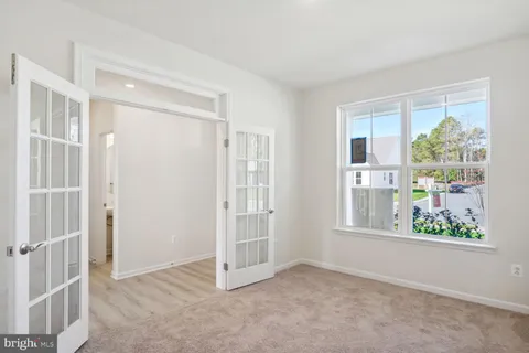 a view of kitchen with furniture and refrigerator
