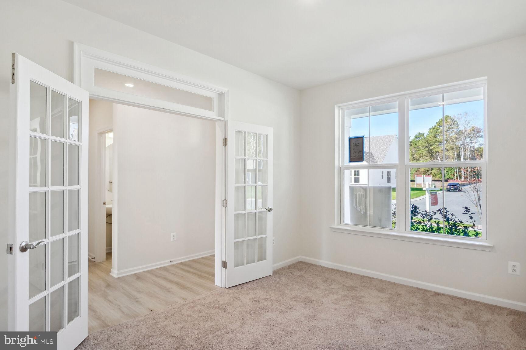 25017 Cypress Court Lewes, DE 19958 - Photo 11 of 14 an empty room with windows and closet