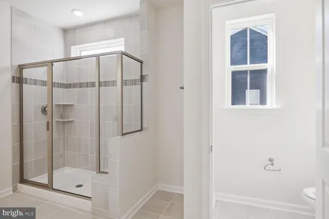 a bathroom with a glass shower door