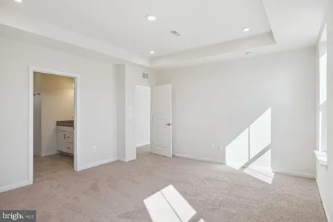 an empty room with windows and closet