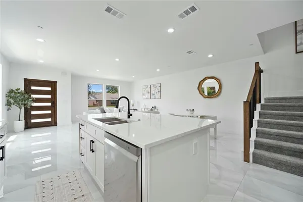 a kitchen with a sink and cabinets