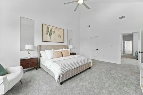 a spacious bedroom with a bed and a couch