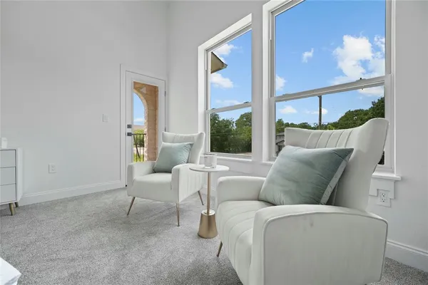 a living room with furniture and a floor to ceiling window